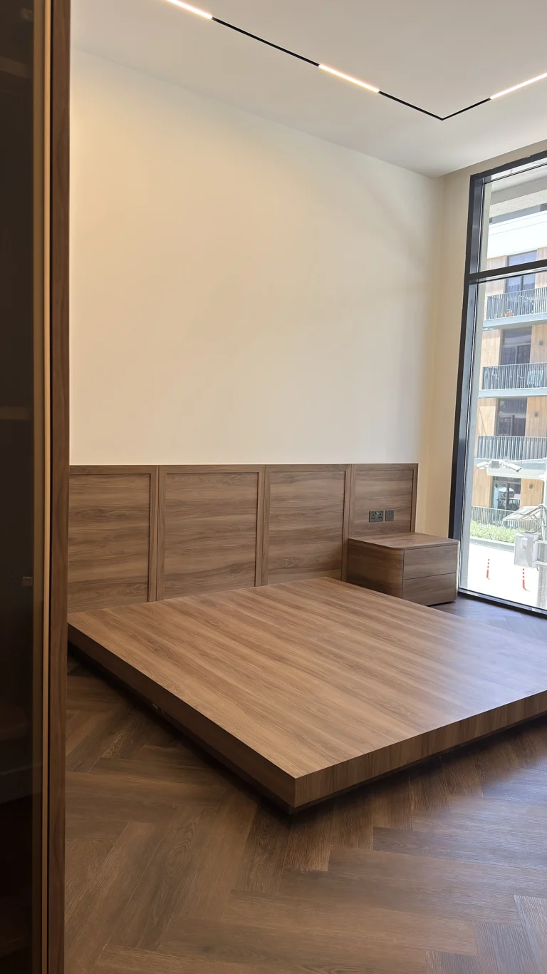 Bedroom fit-out in Dubai with bespoke platform bed and panelled headboard wall