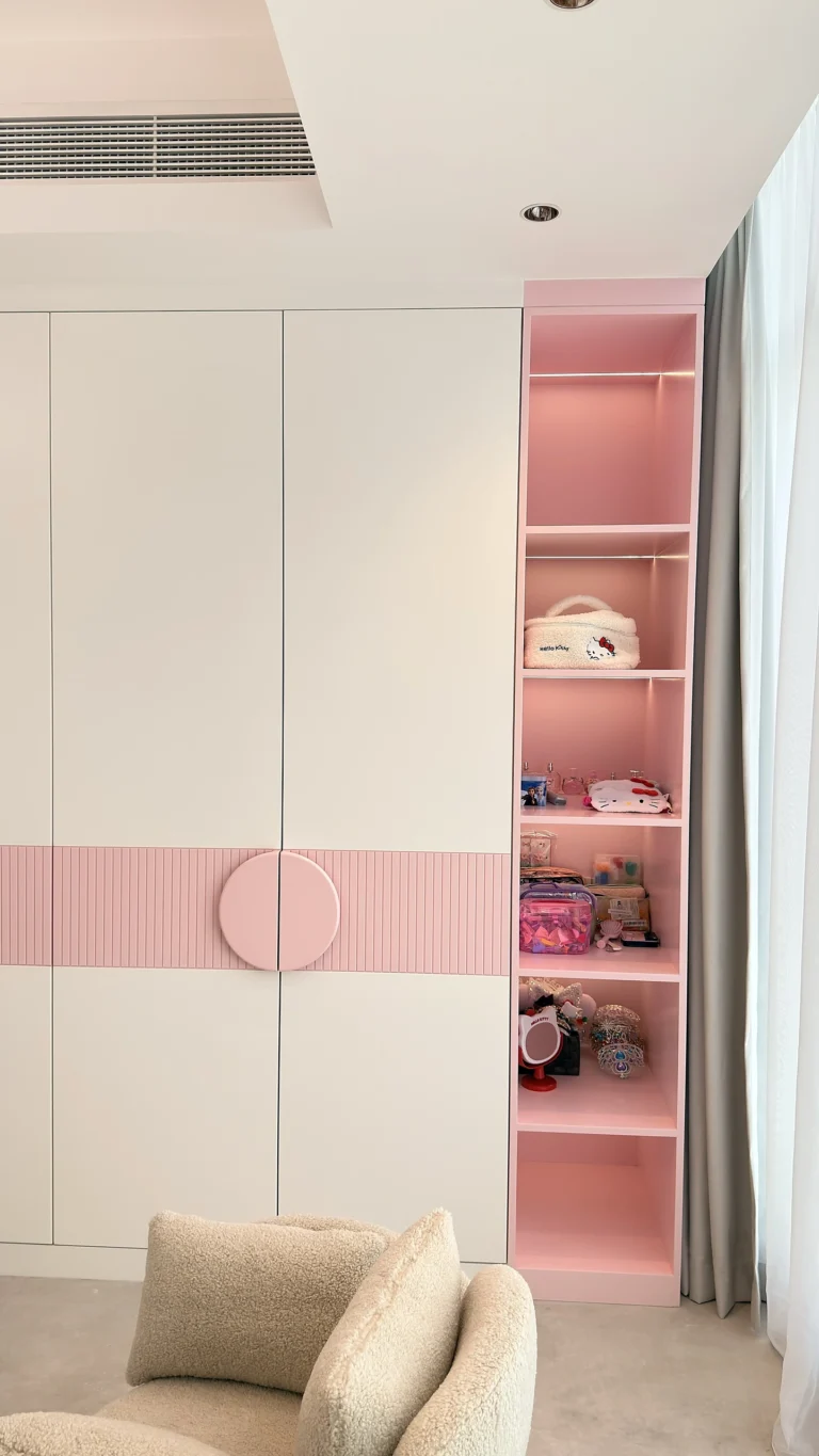 Fitted kids wardrobe in Dubai with white doors and pink open shelving