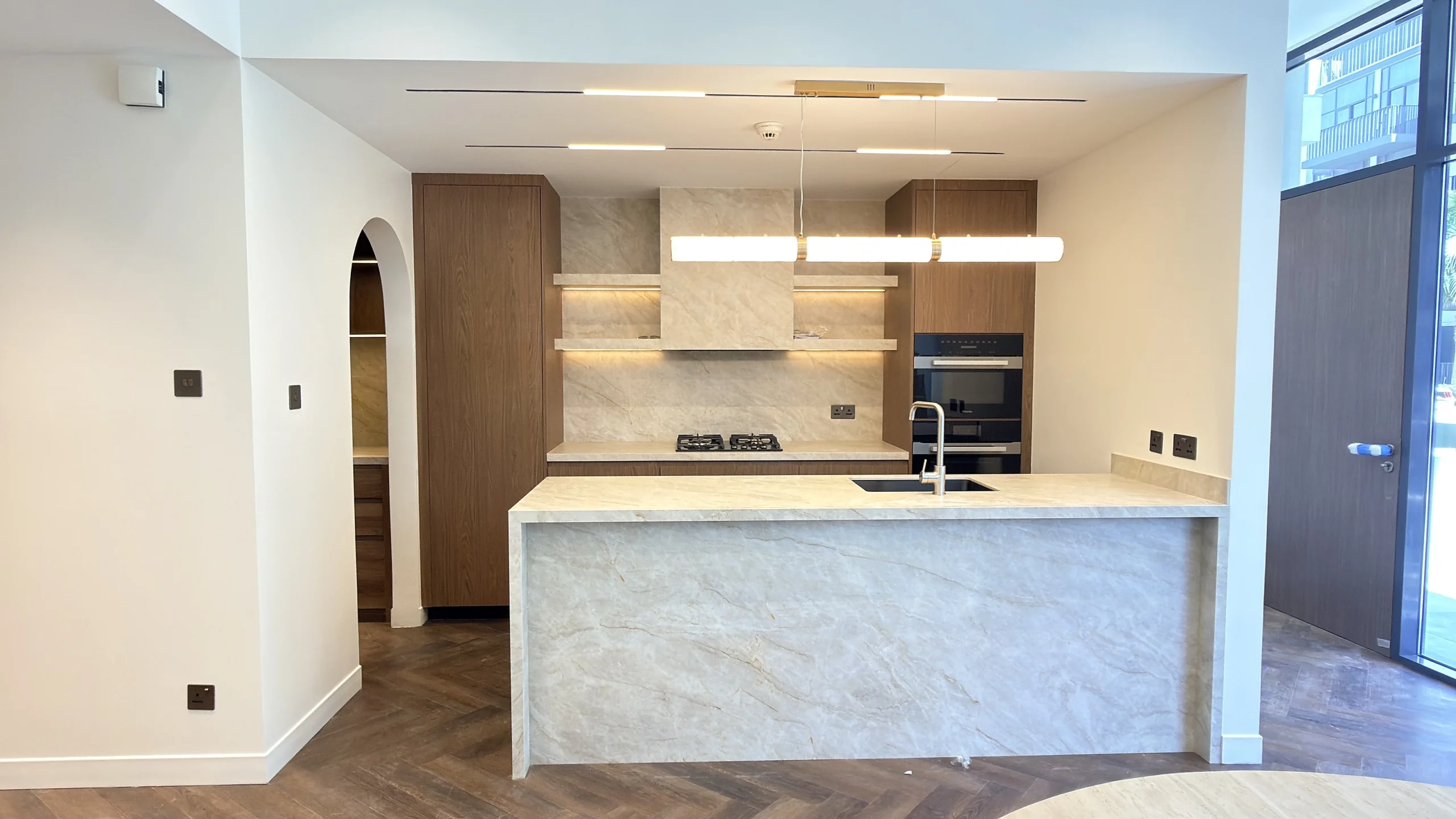 luxury-kitchen-fit-out-dubai-marble-island-walnut