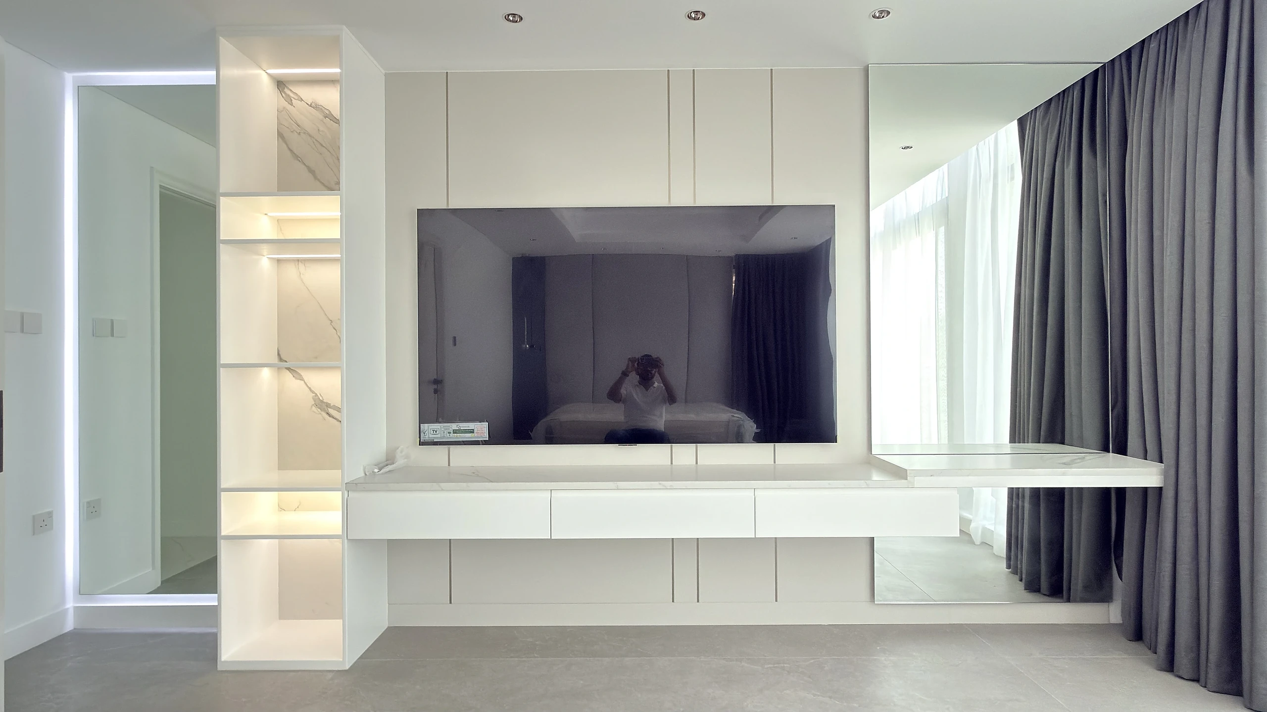 Bespoke TV unit and media wall in Dubai with LED-lit shelving