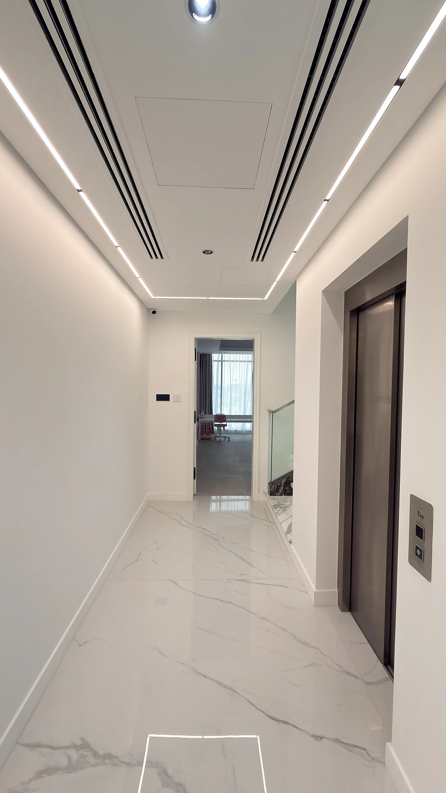 Villa corridor in Dubai with white PU painted doors, marble floor and linear lighting
